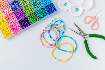 Set of for needlework and beading. Kids handmade beaded jewelry and different multi-colored beads...