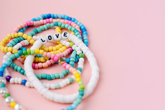 Kids handmade beaded jewelry. Necklaces and bracelets made from multicolored beads and pearls. DIY bracelet beads. Children's needlework. Creativity and hobby. Art activity for kids