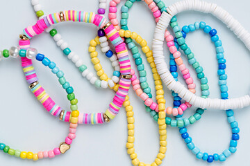 Kids handmade beaded jewelry. Necklaces and bracelets made from multicolored beads and pearls. DIY...