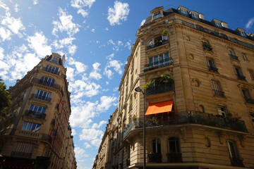 The facades of traditional French houses with typical balconies and windows. Paris. - 624100922