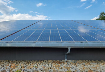 solar panels on the roof of a house, blue sky background