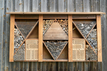 wooden window as insect hotel or bug hotel, nest sites for insects