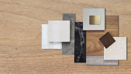 top view of interior luxury sample materials placed on wooden table including black and gery marble...