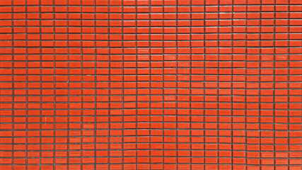 close up terra cotta colored mosaic wall tiles. ceramic tiles in rectangle pattern, orange color....