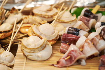 Grilled scallops on skewers in a traditional market