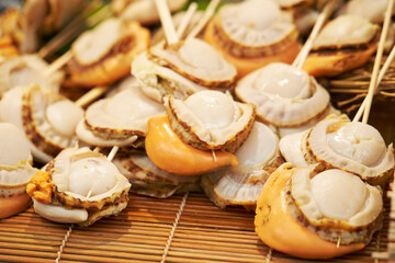 Grilled scallops on skewers in a traditional market