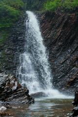Mountain waterfall, large water flow of mountain waterfall, mountain river near the rock. Huk Waterfall, Ukrainian Carpathians - obrazy, fototapety, plakaty