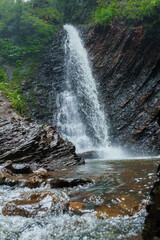 Mountain waterfall, large water flow of mountain waterfall, mountain river near the rock. Huk Waterfall, Ukrainian Carpathians - obrazy, fototapety, plakaty