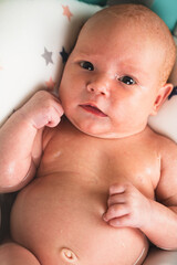 A newborn baby takes a bath. A lovely child is undergoing military training for the first time. The concept of children and hygiene