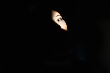 young woman with shadow on the face. female eye