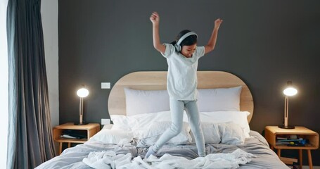 Young girl, dancing and bed at home with music and happy from song in morning. Youth, dancer and headphones with dancer and comedy in a house bedroom with a child and energy of a kid with audio