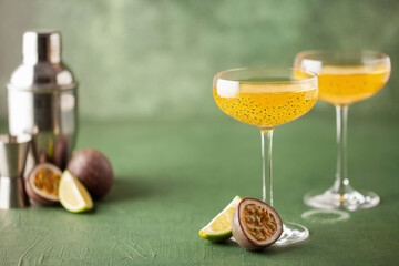 Passion fruit martini cocktail. Sour alcoholic drink with fresh passion fruit and lime, with bar...