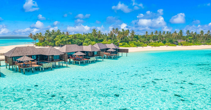 Maldives paradise island. Tropical aerial landscape, seascape pier, water bungalows villas amazing sea lagoon beach. Exotic tourism destination, summer vacation. Beautiful nature, palm trees sea sky