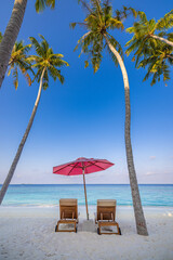 Beautiful tropical beach leisure banner. Couple chairs umbrella white sand coco palm trees travel honeymoon wide panorama background. Amazing landscape. Luxury island resort vacation, sunshine sea sky