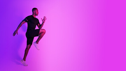 Fototapeta na wymiar Black Athlete Guy Jumping Exercising During Training On Purple Background
