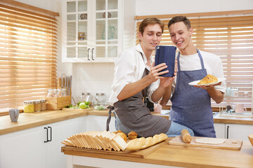 LGBT gay couple bake bakery together and video call to someone in the kitchen