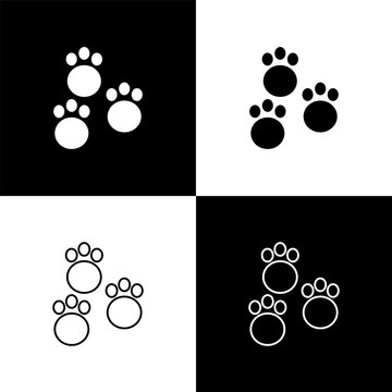 Set Paw print icon isolated on black and white background. Dog or cat paw print. Animal track. Vector