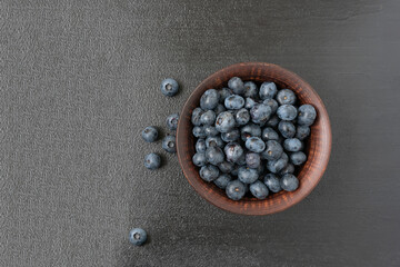 Fresh blueberries in a bowl on a dark background