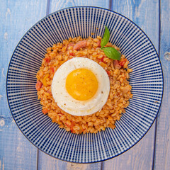 RECIPE FOR BLE WITH BACON, TOMATO AND SHALLOTS, SERVED WITH FRIED EGG. High quality photo