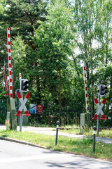 Fototapeta na wymiar Level crossing with barriers, traffic lights and St. Andrew's cross