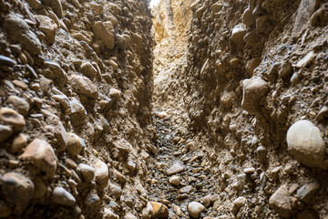 Close Up of A Narrow Path with Sandstone Walls With Round Rocks in the Valley of the Spirits