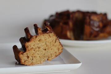 Slices of flower shaped whole wheat plantain cake topped with chocolate sauce