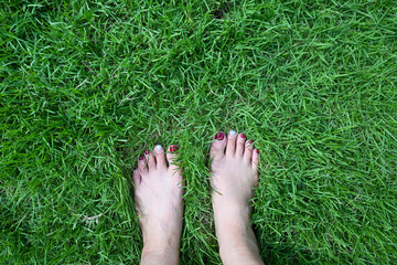 Barefoot on grass, earthing grounding energy, Alternative holistic healing with nature. Earthing (grounding) connects people to the Earth's natural healing energy.Back to nature, mother Earth, Gaia 
