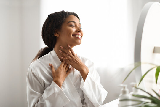 Neck Lift Concept. Smiling African American Woman Touching Her Soft Smooth Skin