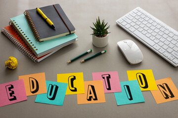 Education, Inscription on colored sticky notes on a gray desk among accessories that help in...