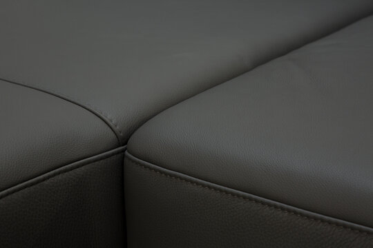 Corner sofa made of leather. Photograph of details in an interesting light