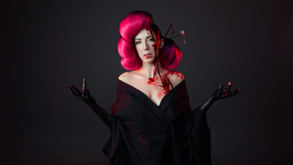 fighting geisha in a black kimono splashes blood on her face. Halloween image. young multiethnic...
