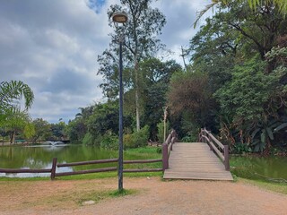 Guarulhos, São Paulo, Brazil - June 30, 2022. View of the two wooden bridges, fountain and lake in Bosque Maya in Guarulhos.