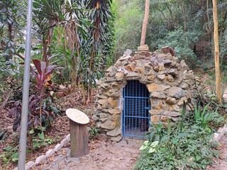 Guarulhos, S&atilde;o Paulo, Brazil - June 30, 2022. Grotto and a plaque with information about the grotto. It is located in the Mayan forest. In Guarulhos - S&atilde;o Paulo.