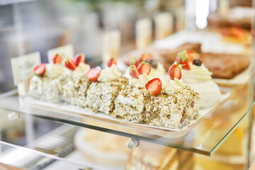 fresh pastries with berries. A variety of fresh pastries in the bakery window. almond croissant is fresh and hot in a cafe next to other types of pastries. The interior of an Italian restaurant.