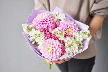 Incredible dahlias are the main flower. Beautiful bouquet of mixed flowers in woman hand. Floral shop concept . Handsome fresh bouquet. Flowers delivery.