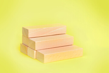 Blank wooden blocks on yellow background