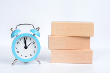 Isolated alarm clock and wooden blocks on white background