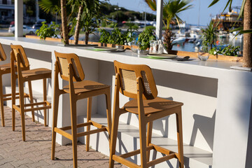 vacant bar chairs at seaside restaurant
