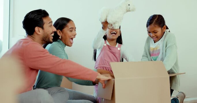 Mother, father and children in new home for fun, box and toys or happy celebration for fresh start at property. Parents, girl kids and moving with cardboard package, excited and play in family house