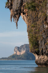 wall of limestone cliffs over the ocean, Phra Nang beach, Krabi, Thailand