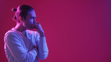 Pensive guy. Neon light people. Idea contemplation. Blue pink confused puzzled man thinking on purple color gradient empty space background.