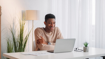 Online coach. Video conference. Business communication. Internet call. Cheerful man employee discussing corporate project at laptop virtual meeting at office workplace.