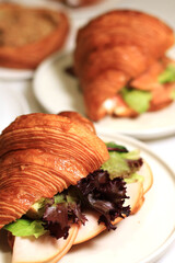 food, croissant, breakfast, bun, sandwich, bread, snack, french, meal, pastry, lettuce, lunch, cheese, delicious, fresh, white, meat, bakery, dinner, homemade, fast, ham, slice, background, table, woo