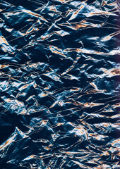 Wrinkled texture. Abstract background. Damage screen. Grunge black paper with yellow white neon glow pattern surface.