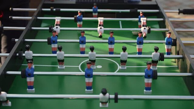 Table football ball rally in open air ending in goal. Play kicker and determine winner in complex combinations with help of dexterous movements. Gambling entertainment for group of people.