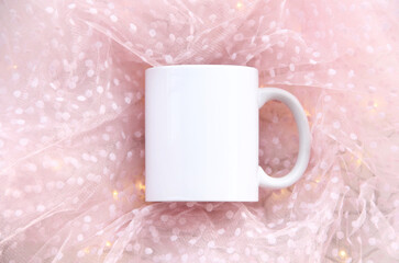 white 11 oz mug on a pink background with lights. White cup mock up 