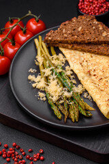 Delicious nutritious breakfast consisting of asparagus, scrambled eggs, salt, spices and herbs
