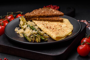 Delicious nutritious breakfast consisting of asparagus, scrambled eggs, salt, spices and herbs