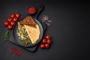 Delicious nutritious breakfast consisting of asparagus, scrambled eggs, salt, spices and herbs