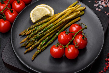 Delicious nutritious breakfast consisting of asparagus, tomatoes, salt, spices and herbs